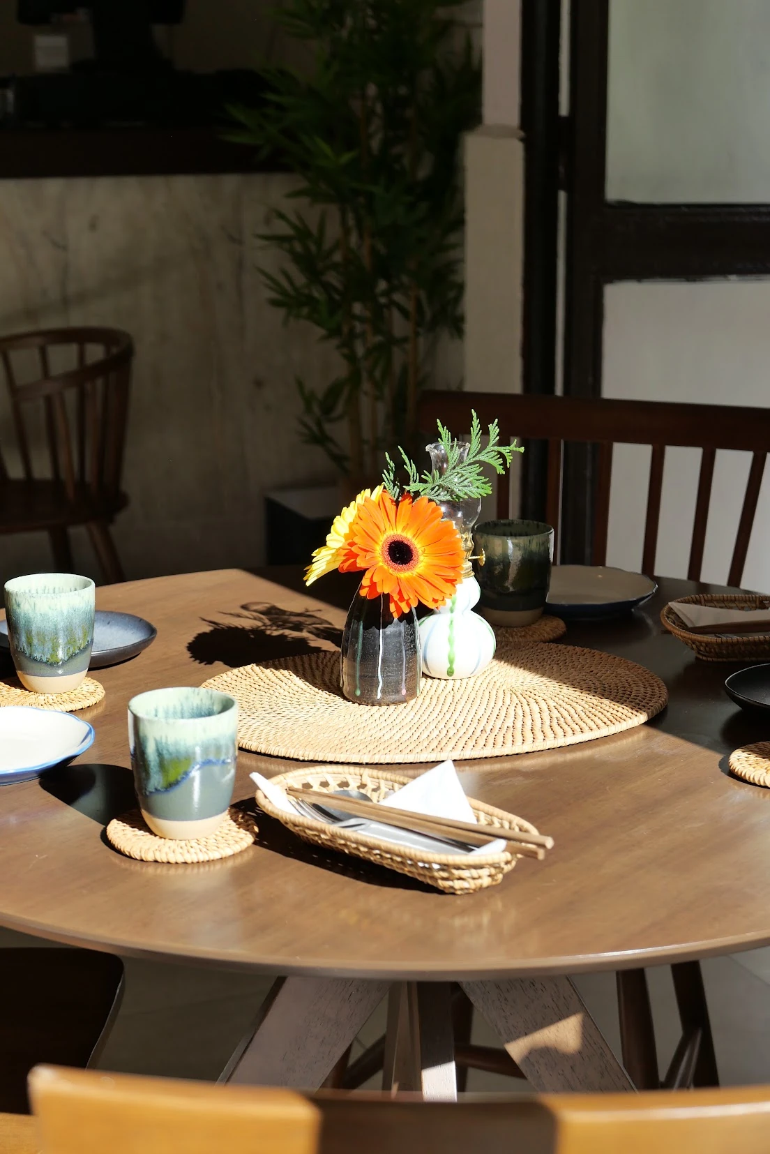 Sunlit table with ceramics and a sunflower at B’My La Latina